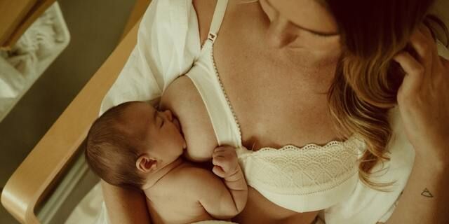 Woman wearing supportive maternity bra through pregnancy and nursing